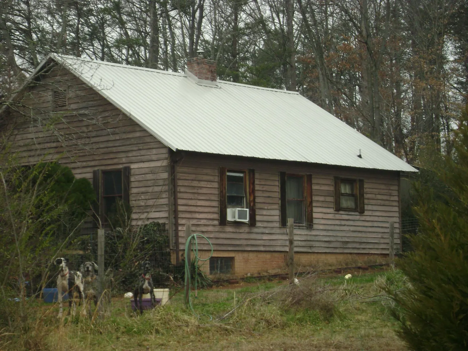 White metal roof on an old wood sided farmhouse, from a Metal Roof Installation job in Bremen